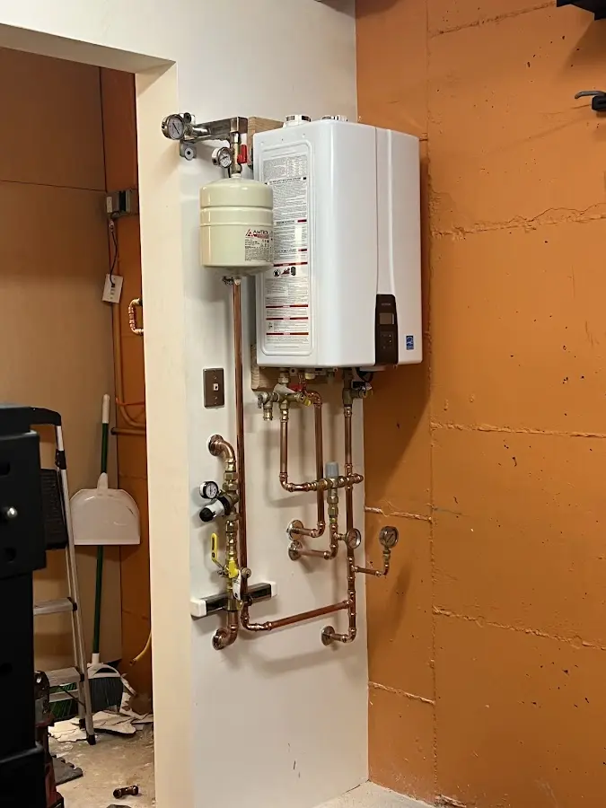 Plumbing technician inspecting water heater connections in Fairview Shores